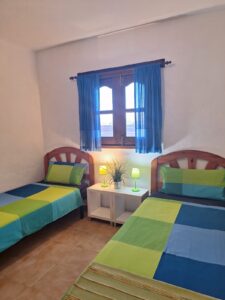 Dormitorio con dos camas de la Villa con cuatro apartamentos independientes en Lajares