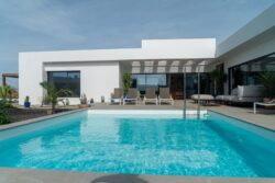 Modern pool and sun lounger area designed by Innova Home at Villa Gaia.